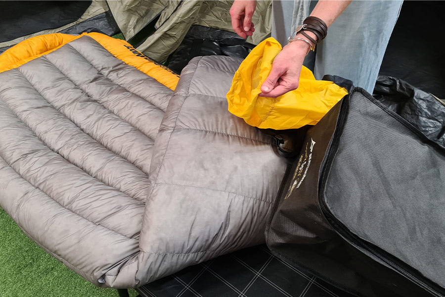 Sea to Summit's Spark Sp4 Sleeping Bag with yellow stuff sack and storage bag.